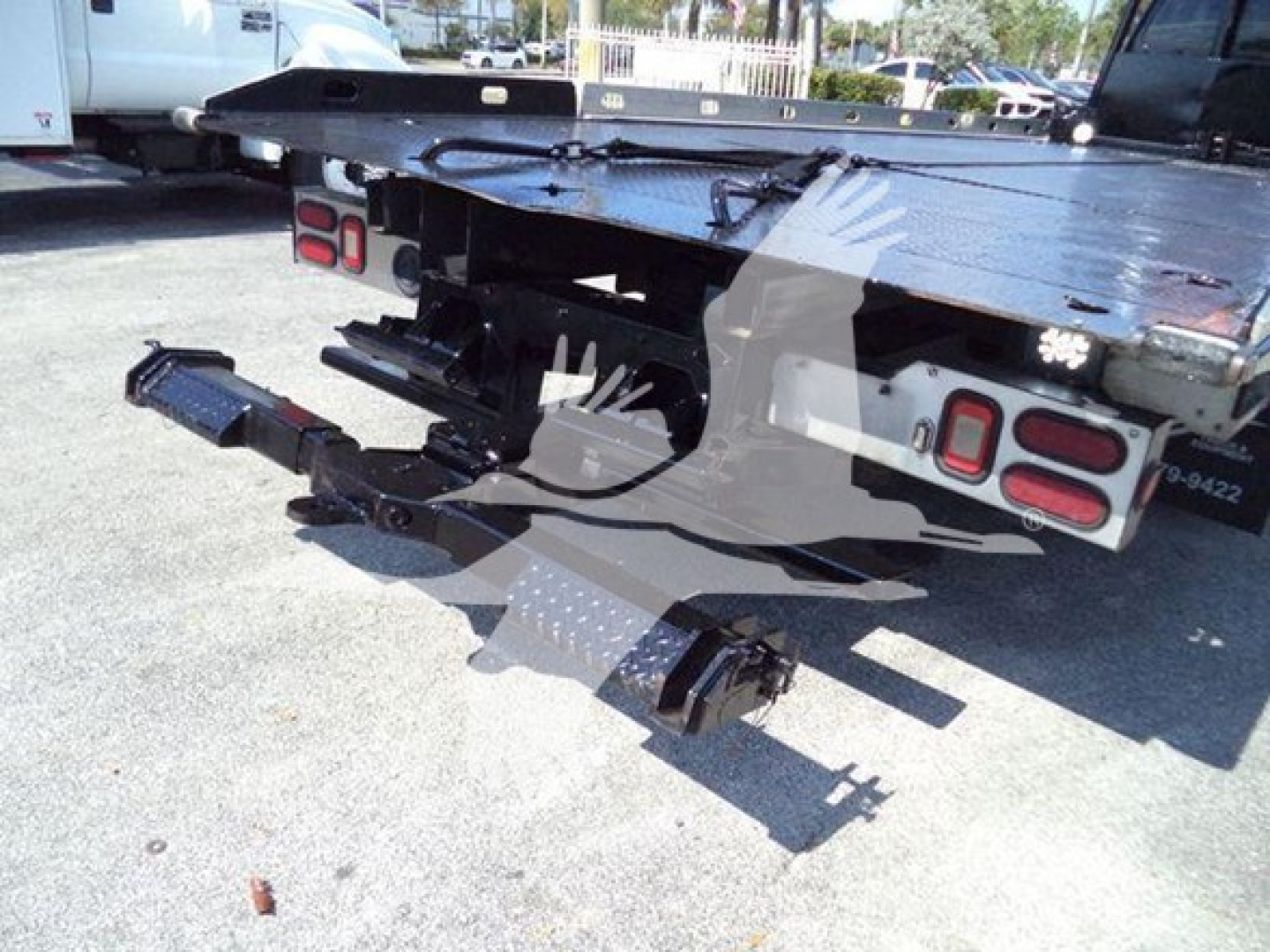 Rear of 2017 Ford F650 rollback truck showing hitch assembly, bumper, and taillights with platform and equipment mounting.