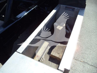 Truck bed with wood blocks and a stenciled graphic of hands forming a bird, visible inside the cargo area of a 2017 Ford F650 rollback truck.