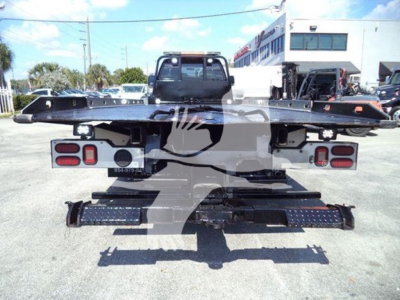 Back view of a 2017 Ford F650 rollback truck chassis with tow platform and rear lights; vehicle is in a dealership lot.