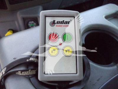 Ldar control module in Ford F650 rollback setup showing control panel with green power button and yellow indicators, mounted near cup holder area.