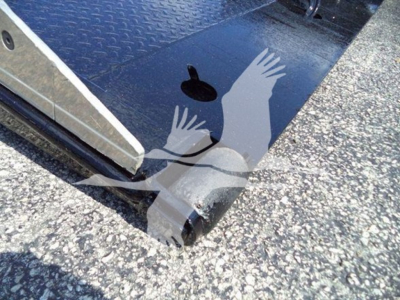Ford F650 rollback truck wheel well and entering ramp edge with metal plate and textured floor.