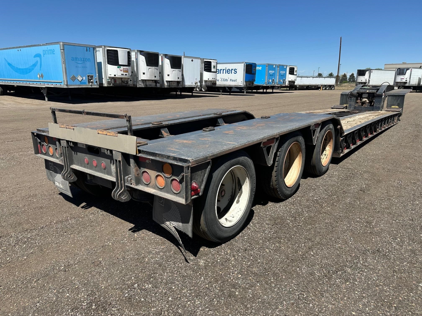 Trailer: 2008 Trail King 50 Ton Lowboy with pony motor, 25'5" well, rear view showing multiple axles and weathered deck.