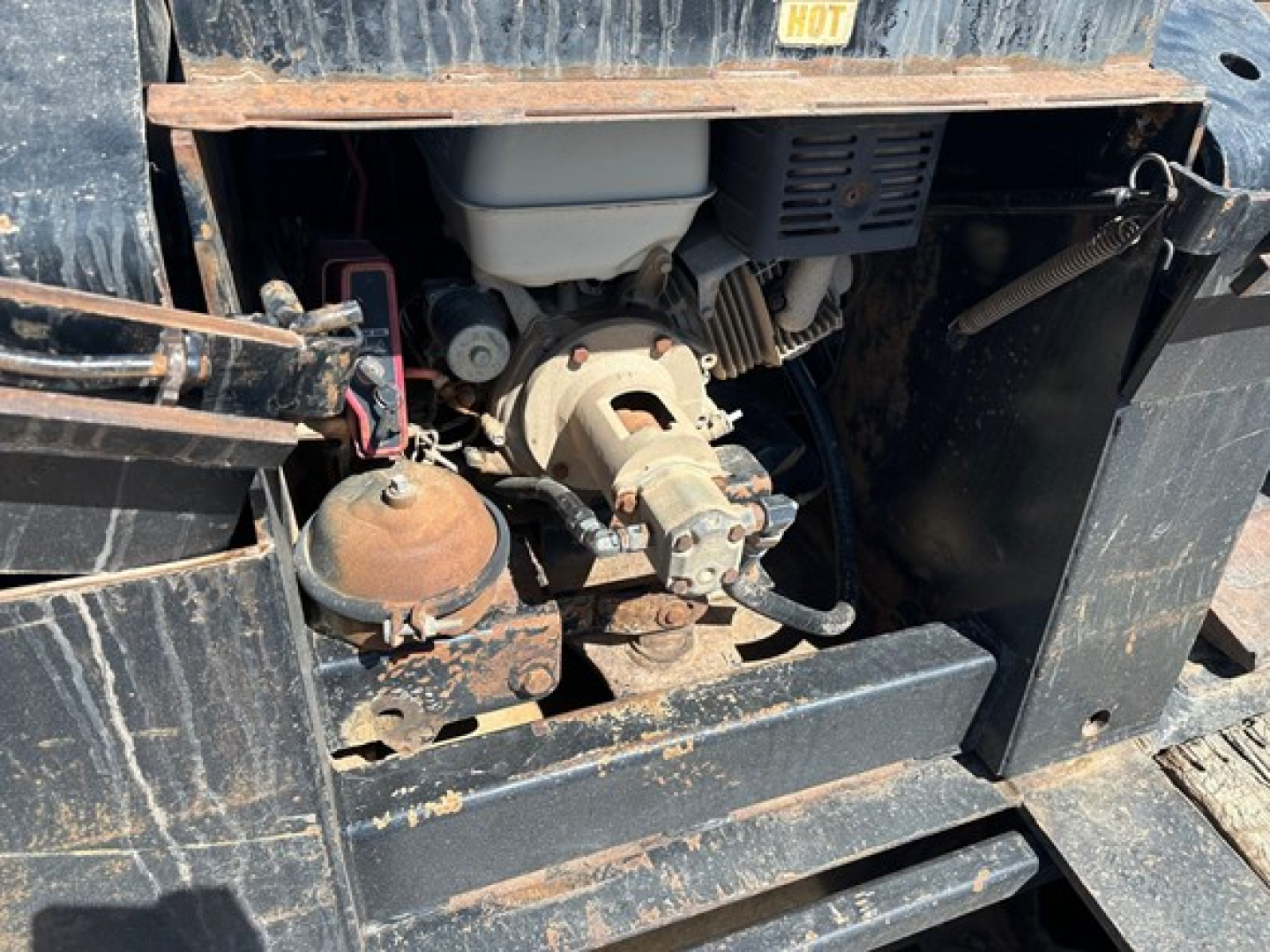 Trailer king 50 ton lowboy engine bay showing pony motor and hydraulic pump with rust and dirt