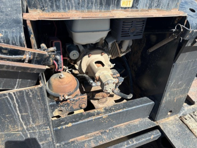 Trailer king 50 ton lowboy engine bay showing pony motor and hydraulic pump with rust and dirt