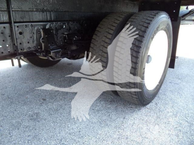 Isuzu NPR HD truck rear showing dual rear wheels and undercarriage components.