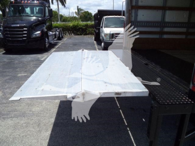 Isuzu NPR-HD truck bed platform/flatbed in view with other trucks in background.