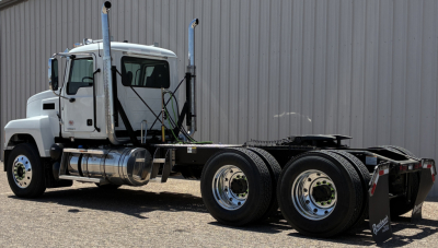 Truck chassis of a 2027 Mack PI64T daycab showing front cab, dual rear axles, and fifth-wheel mounting.