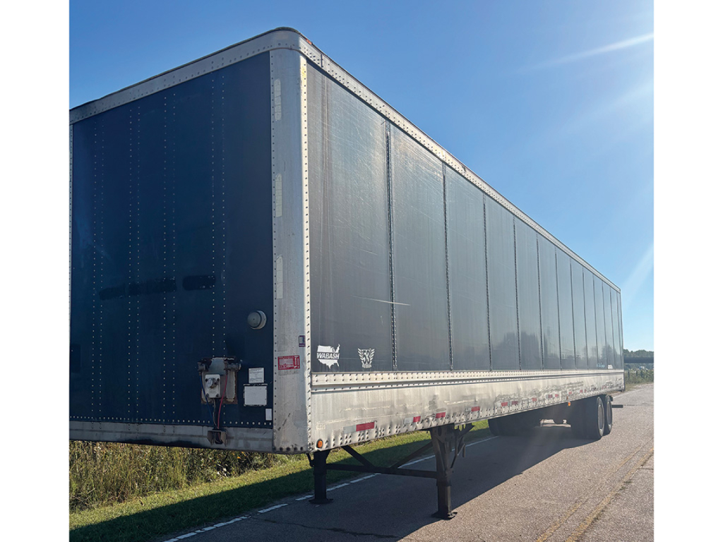 Trailer side view showing a dark blue 2004 Wabash DuraPlate HD dry van trailer with riveted aluminum frame and reflective striping, stock number 560616, VIN 1JJV532W34L883968.
