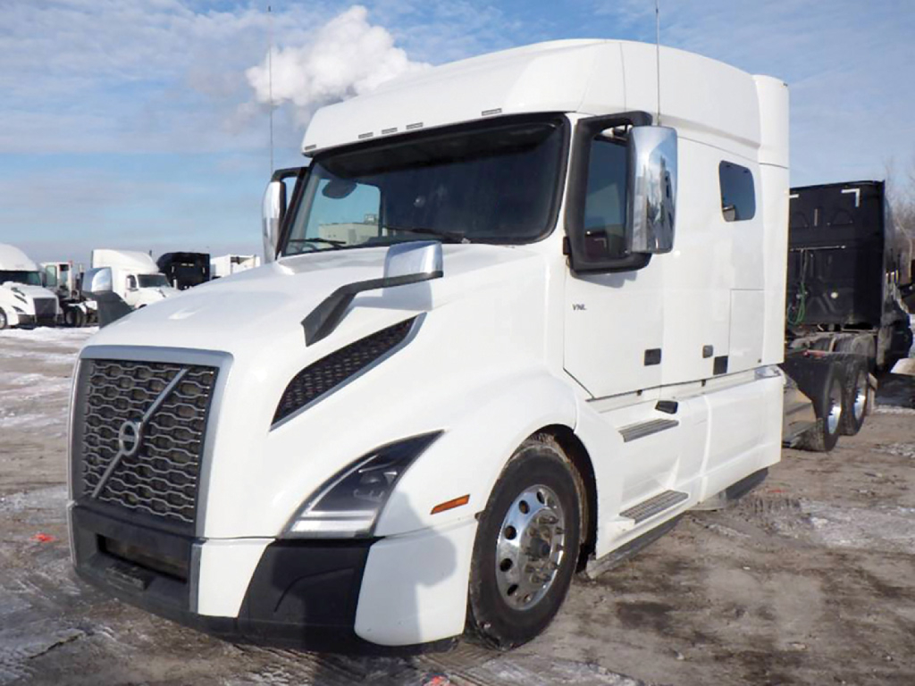 Volvo VNL 740 sleeper cab tractor in a white finish, front-left view showing aerodynamic hood and side mirrors.