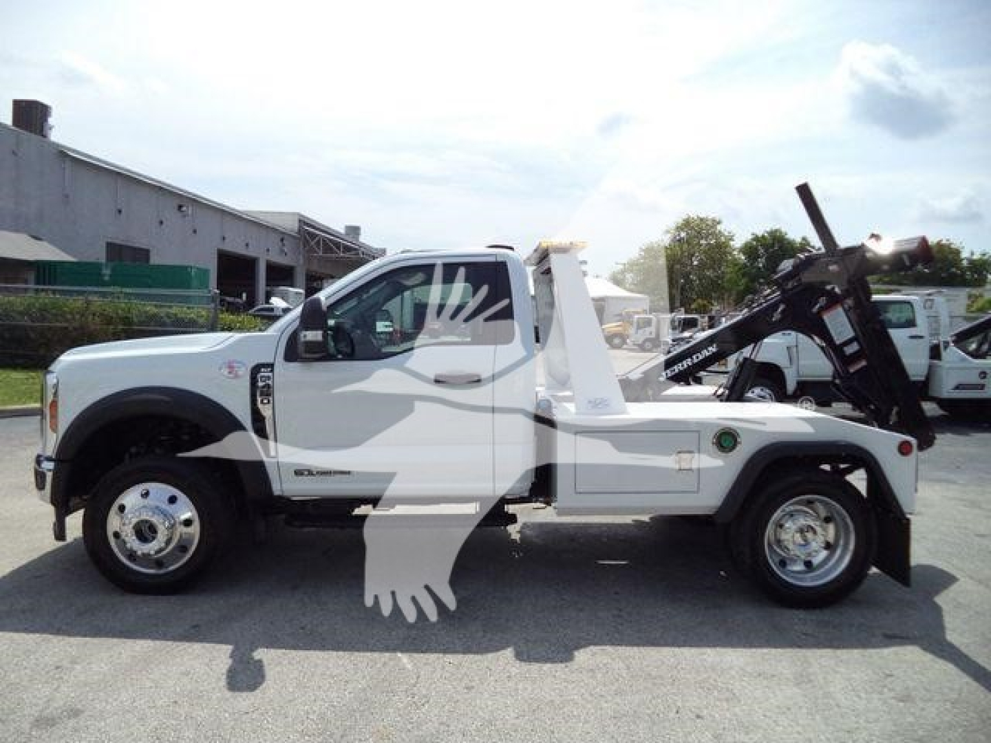 Ford F-450 tow truck side view showing winch equipment and tandem rear axle with dual wheels.