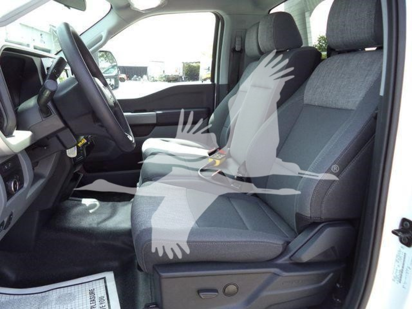 Front interior of a 2024 Ford F-450 truck showing driver seat and front passenger seat with dashboard and steering wheel.