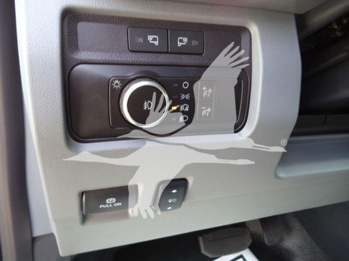 Ford F-450 control panel showing headlight switch and fog light control with push-on switches and a winch category interior feature.