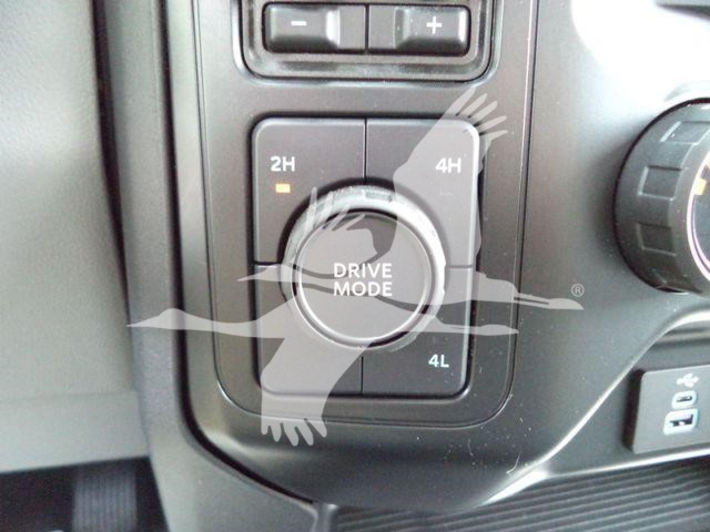 Dashboard drive mode selector showing 2H, 4H, and 4L options around a circular dial in a Ford F-450. The surrounding controls are visible.