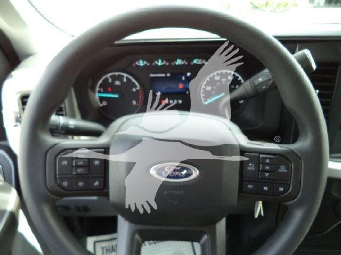 Ford F-450 winch truck steering wheel and instrument cluster visible in cabin interior.