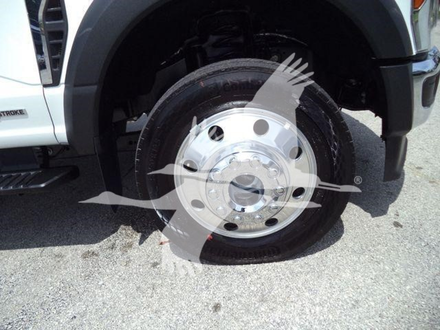 Ford F-450 wheel and tire close-up showing steel rim and tire with wheel well.