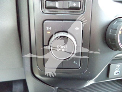 Dashboard drive mode selector showing 2H, 4H, and 4L options around a circular dial in a Ford F-450. The surrounding controls are visible.