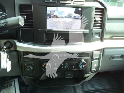 Ford F-450 interior dashboard with center touchscreen display and climate controls, stock keys on the ignition, front cabin view.