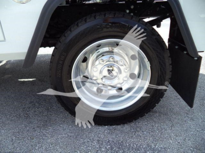 Ford F-450 wheel and tire assembly inview showing steel rim and tire under fender; winch category listing context visible.