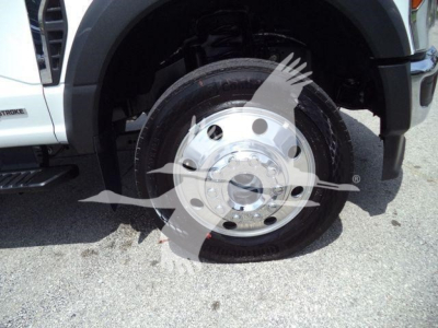 Ford F-450 wheel and tire close-up showing steel rim and tire with wheel well.