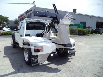 Ford F-450 tow truck with rear mounted hydraulic winch lifting mechanism and boom in loading position