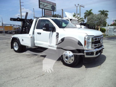 Ford F-450 tow truck in white, front-right angle, stock rack and equipment bed visible