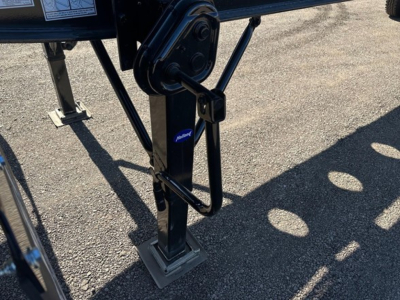 Trailer landing gear with label and hydraulic leg showing pivot point and tube flex corner components.
