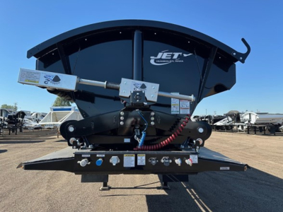 Jet trailer underside showing hydraulic pivot mechanism and control panel with labels and wiring. Front-bottom bar, hoses, and fittings visible.
