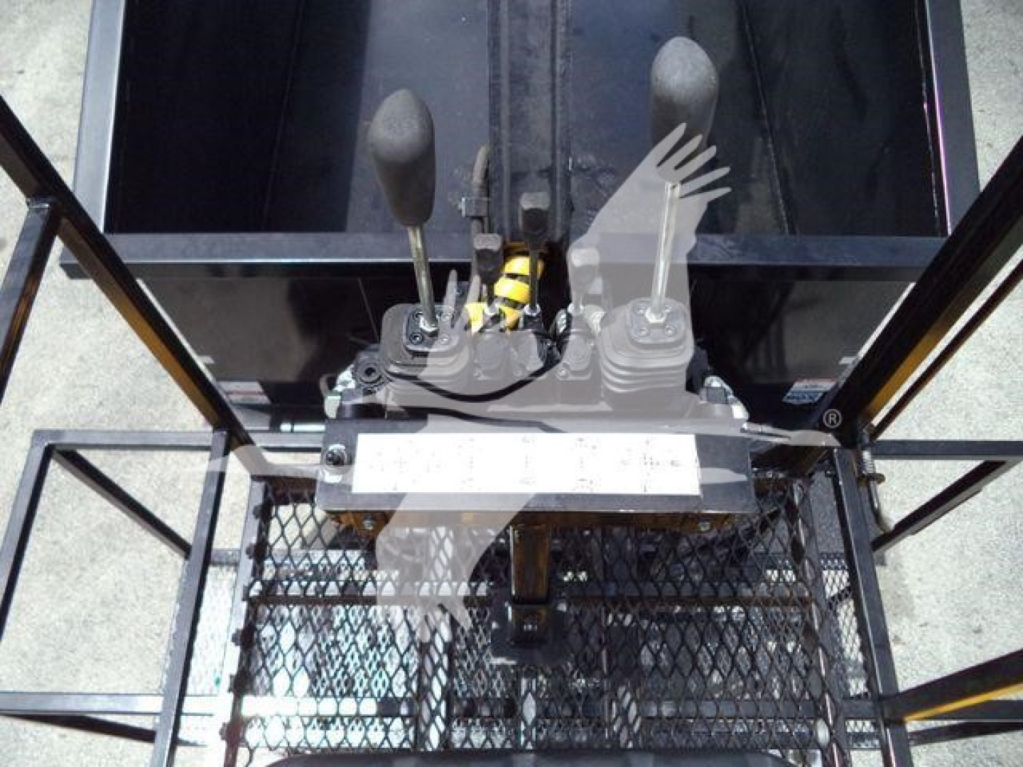 Operator cab view of a hydraulic lever control and forked joystick in a used 2019 International 4300 grapple truck, showing control levers and wiring harness.
