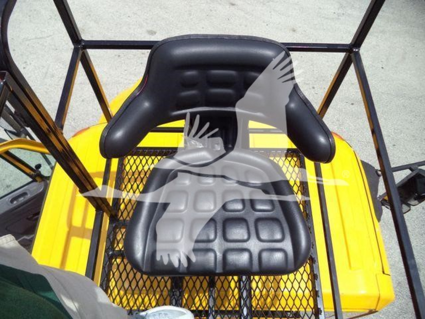 Seat of a 2019 International 4300 grapple truck with black cushioned seat and protective yellow body in the background.