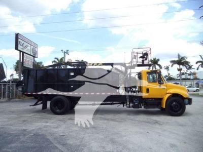 Truck in service showing a 2019 International 4300 grapple truck with a yellow cab and black grapple body.