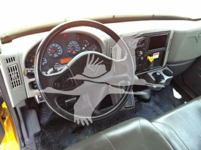 Interior of a 2019 International 4300 cab showing steering wheel, dashboard gauges, center console, and gear area.
