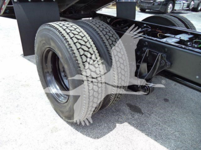 Dual rear tires on a 2019 International 4300 tractor showing tire tread and axle assembly.
