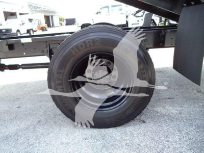 Tire and undercarriage view of a 2019 International 4300 truck chassis showing spare wheel and frame with grapple equipment mounting.