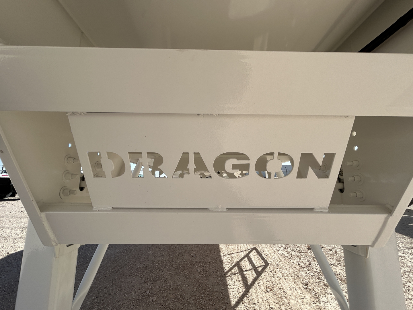 Dragon vacuum trailer showing 'DRAGON' logo cutout on side panel and white metal frame.