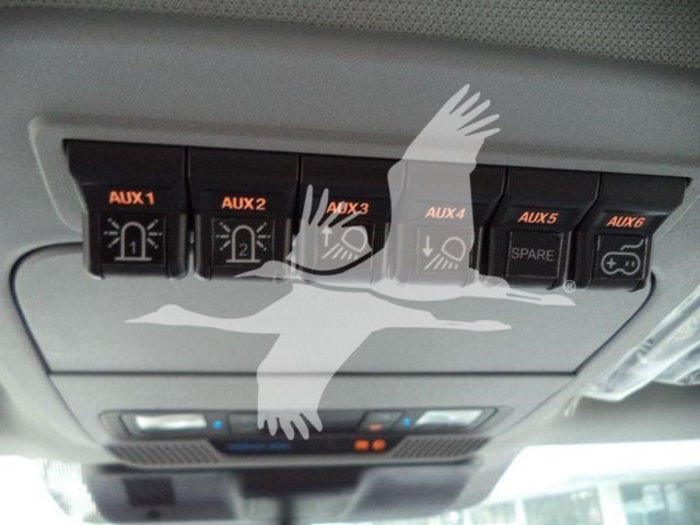 Ford F-450 truck interior overhead auxiliary switch panel showing AUX 1, AUX 2, AUX 3, AUX 4, spare, and control buttons