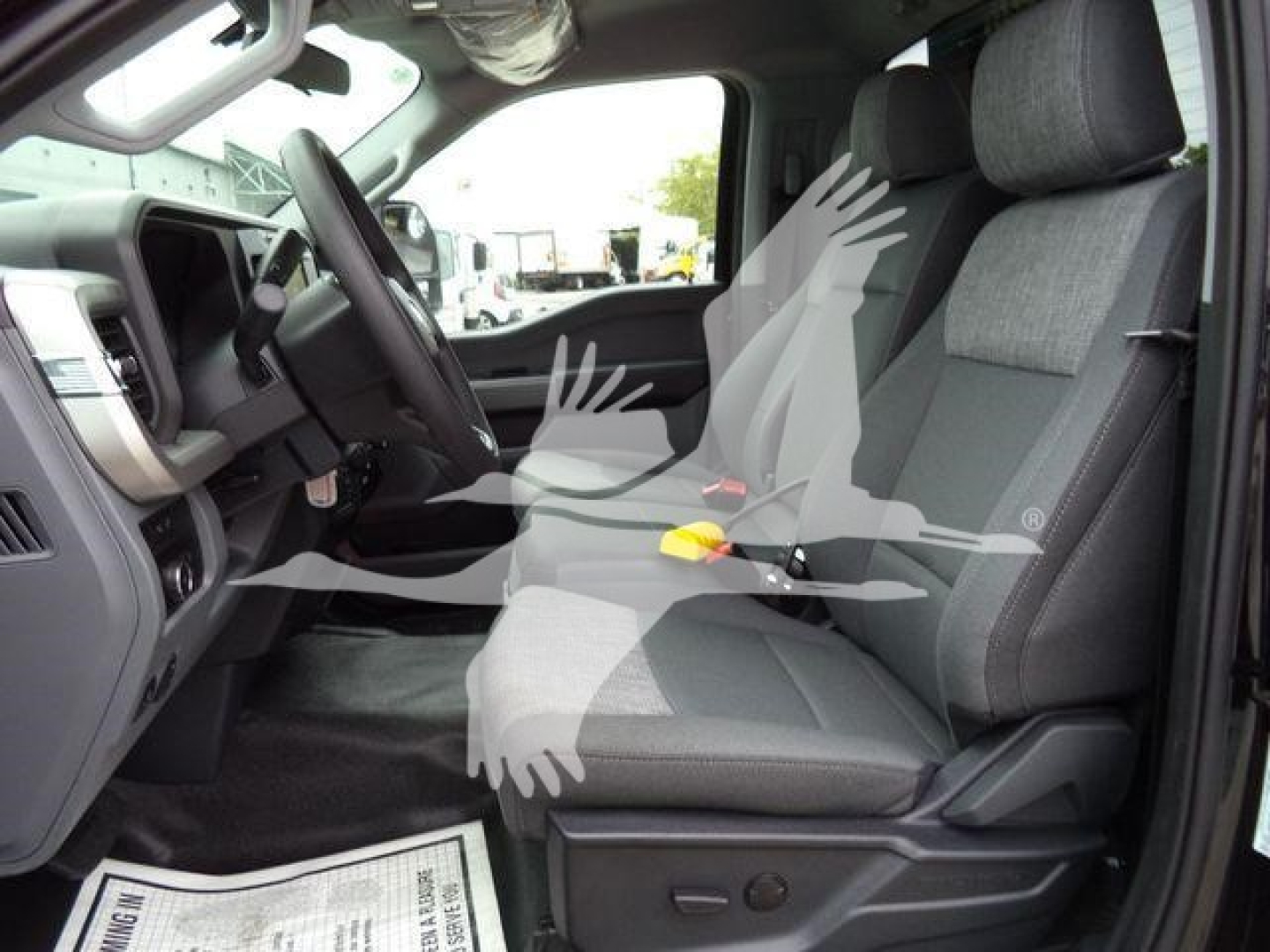 Ford F-450 truck interior showing front seats and dashboard with manual controls.