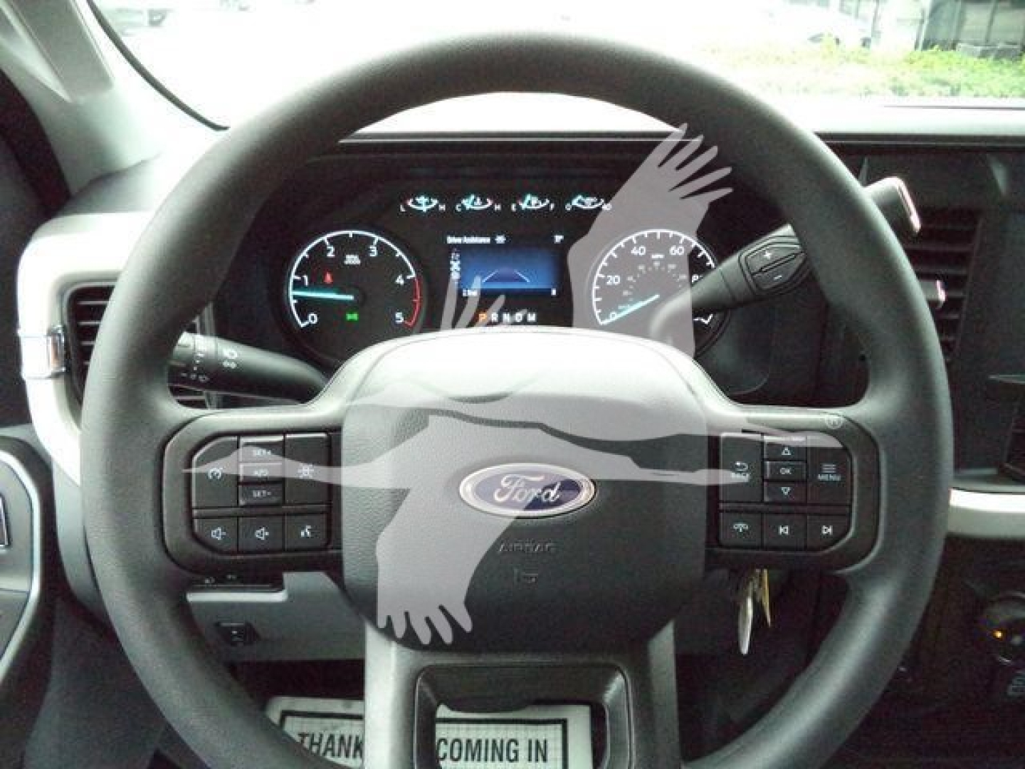 Ford F-450 steering wheel and dashboard with instrument cluster; visible buttons on steering wheel.