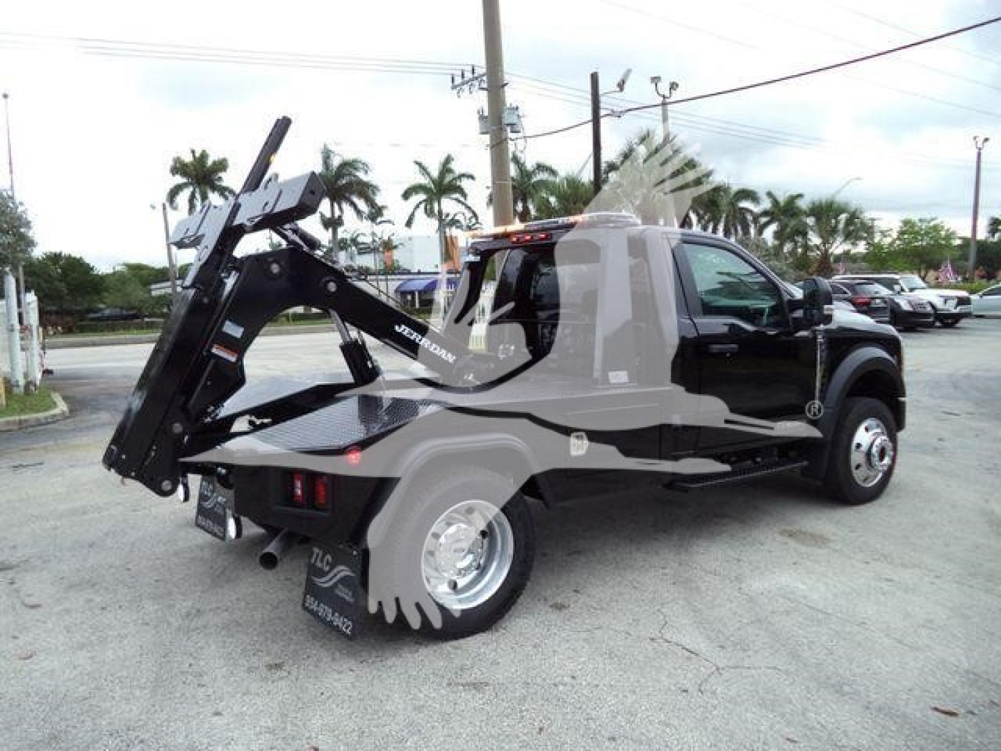 Truck rear with mounted hydraulic winch and heavy-duty tow hook on 2024 Ford F-450 in-service showing winch assembly and back plate.