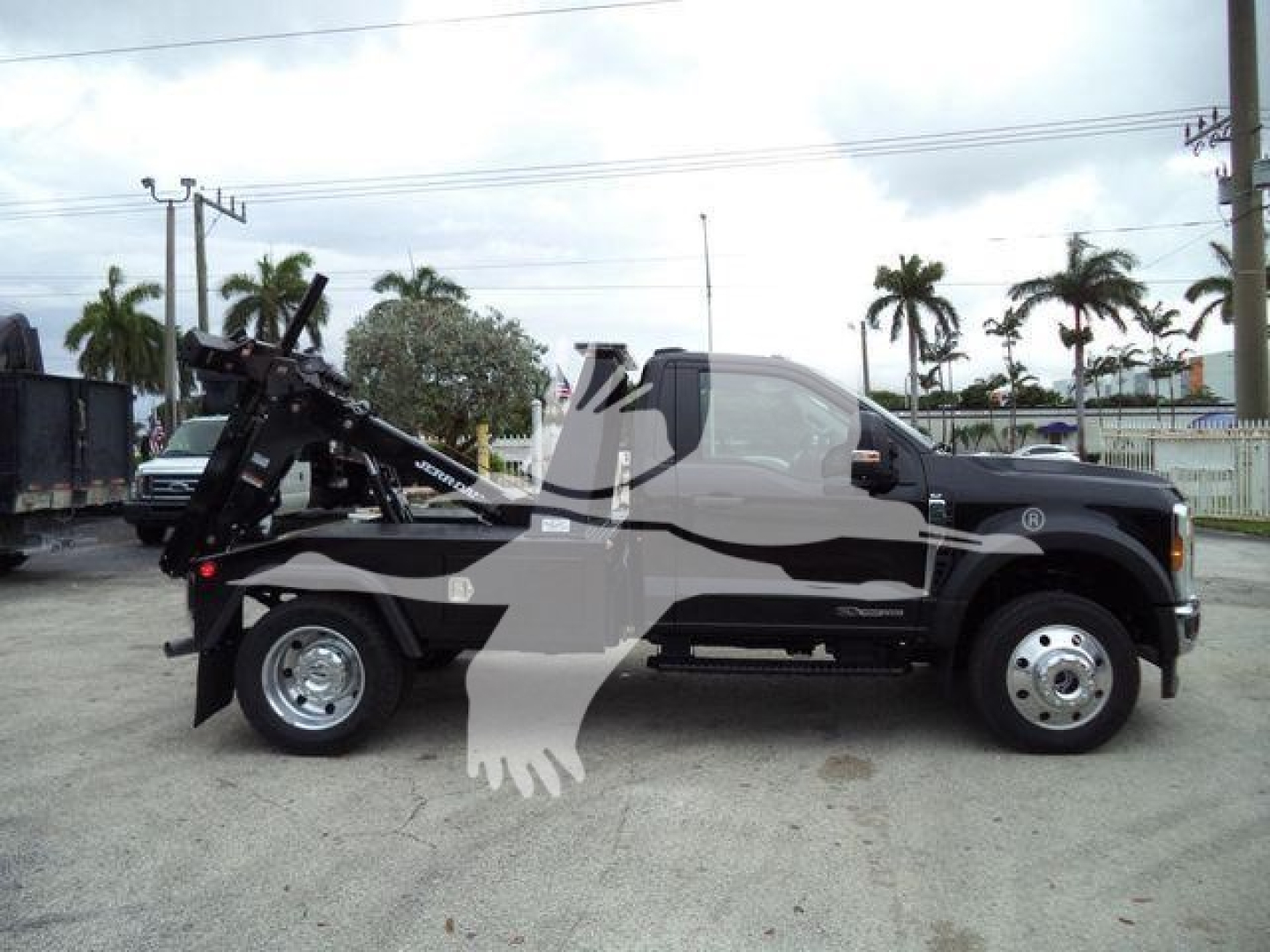 Ford F-450 pickup truck with a winch and towing equipment mounted on the rear, side profile view.