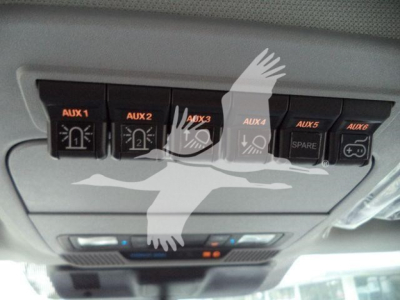 Ford F-450 truck interior overhead auxiliary switch panel showing AUX 1, AUX 2, AUX 3, AUX 4, spare, and control buttons