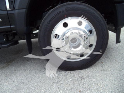 Front wheel of a 2024 Ford F450 with chrome hub and Conti HSR tire; partial vehicle fender and suspension visible.