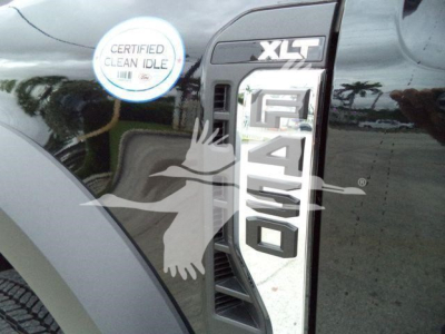 Ford F-450 Super Duty XLT badge on black truck fender with 'Certified Clean Idle' sticker visible.