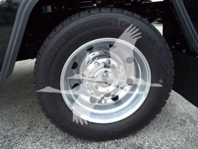 Ford F-450 wheel and tire close-up showing steel rim and tire sidewall with tread pattern.