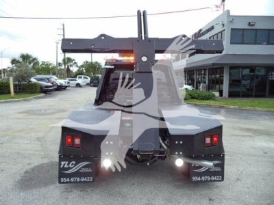 Winch-equipped Ford F-450 rear view showing mounting assembly and bumper lights.
