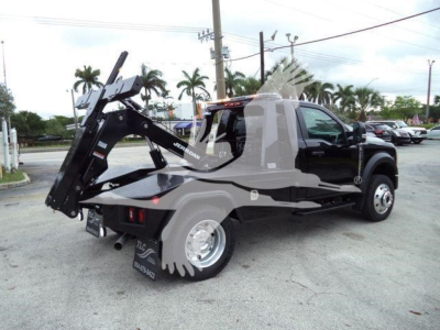 Truck rear with mounted hydraulic winch and heavy-duty tow hook on 2024 Ford F-450 in-service showing winch assembly and back plate.