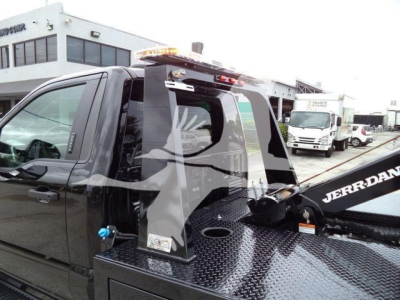 Ford F-450 tow truck with a winch in the bed and JERR-DAN branding, cab side view