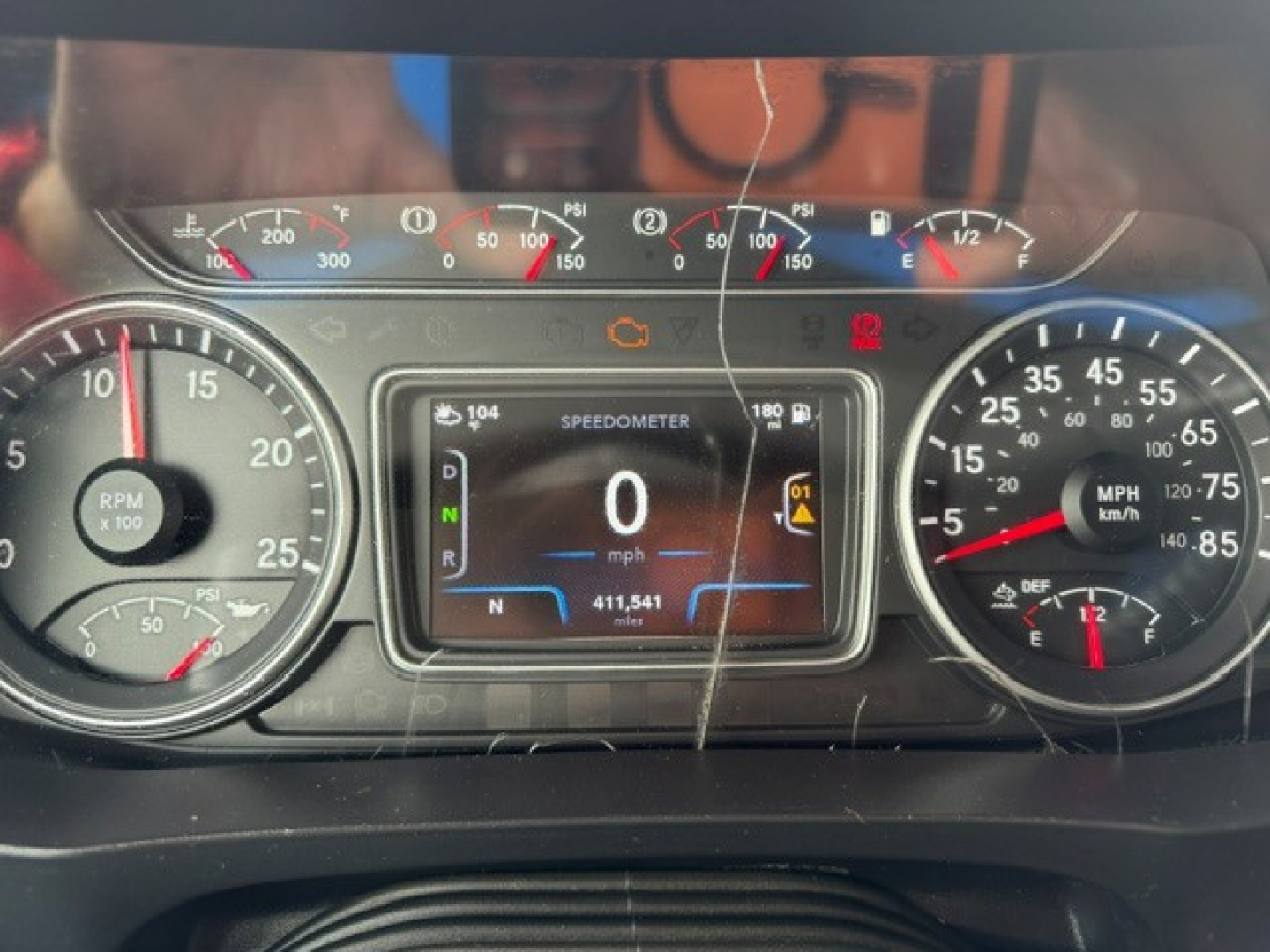Dash cluster of 2022 International LT showing digital speedometer at 0 mph, gauges for RPM and speed, and warning icons visible.