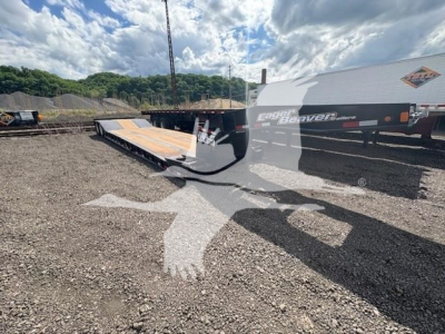 Lowboy trailer in a yard showing Eager Beaver 35Gsl-Pt branding on side and loading ramp extended.