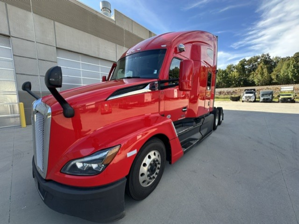 Kenworth T680 conventional sleeper truck in red, front-left view showing cab, mirrors, and wheel