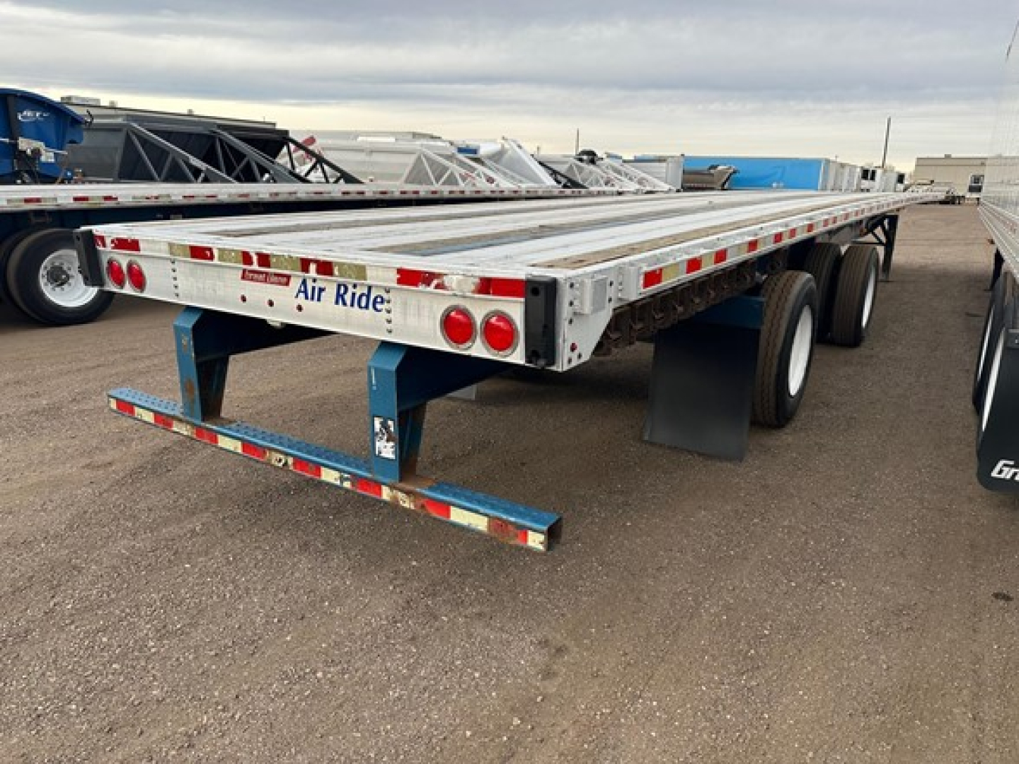 Great Dane Freedom Lt flatbed trailer showing long aluminum deck with dual rear axles and Air Ride branding on stern.